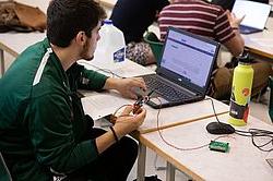 计算机工程 student programming a printed circuit board.